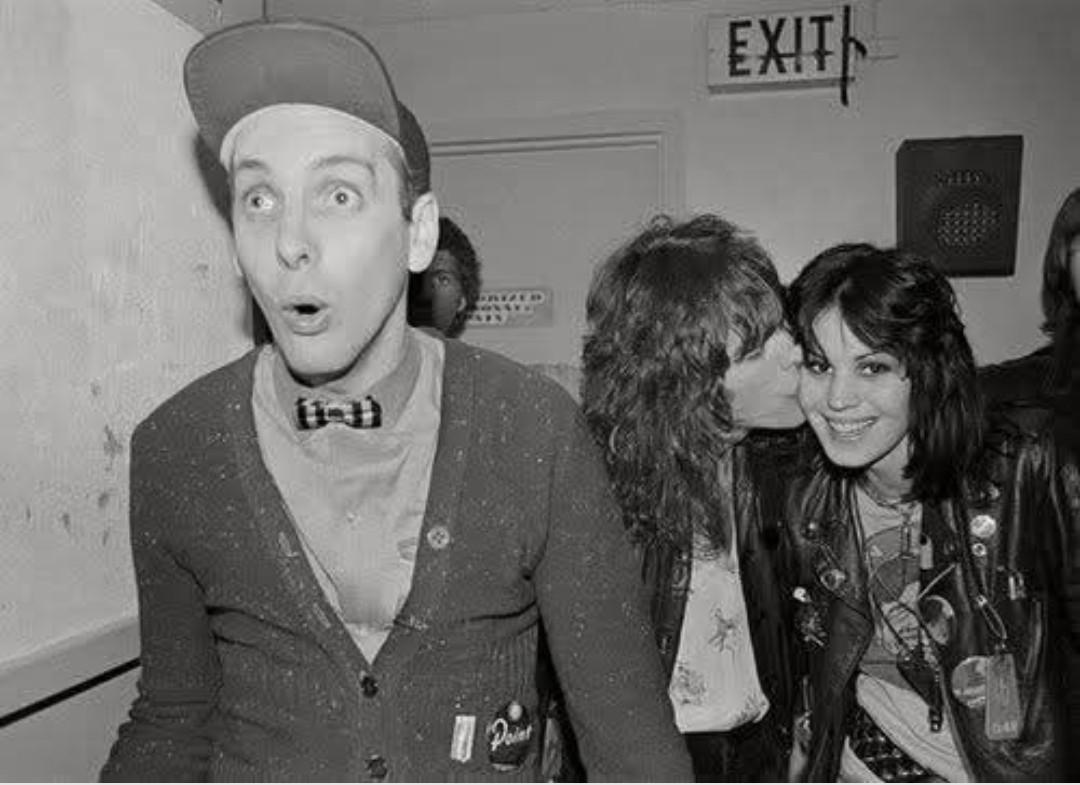 Rick Nielsen, Tom Petersson and Joan Jett having fun backstage.